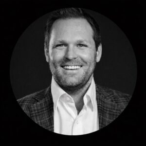 Professional headshot of a smiling man in a blazer, representing leadership and growth in consulting services for mission-driven organizations at Stratica AX.