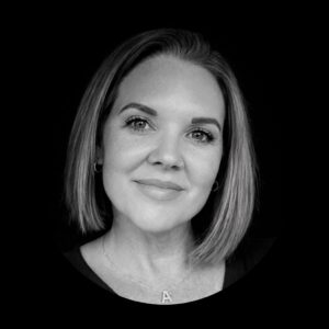 Professional portrait of a woman with a short bob hairstyle, smiling warmly, representing Stratica AX's leadership in fractional business development and consulting services.